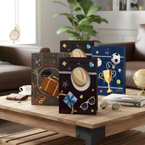 Four decorative boxes with various designs on a wooden table in a living room setting.