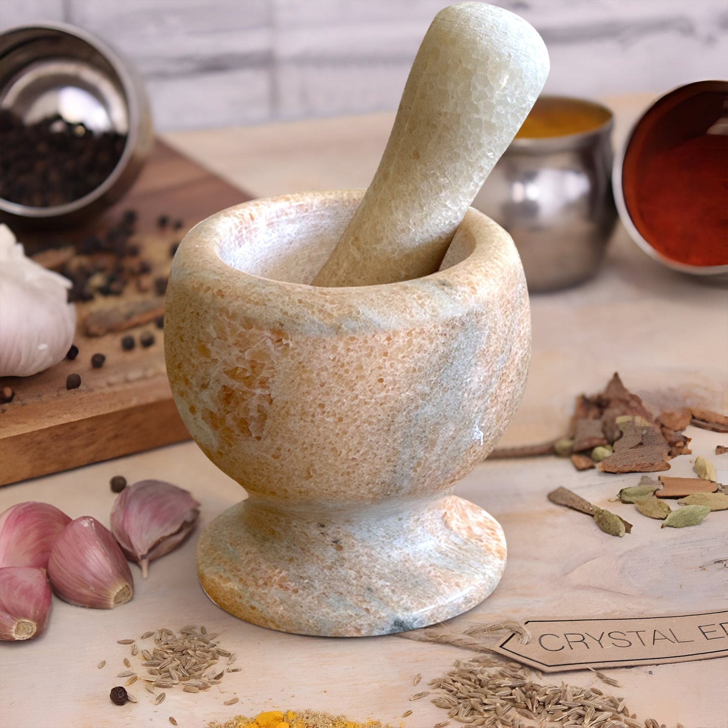Stone mortar and pestle with spices and herbs on a wooden surface