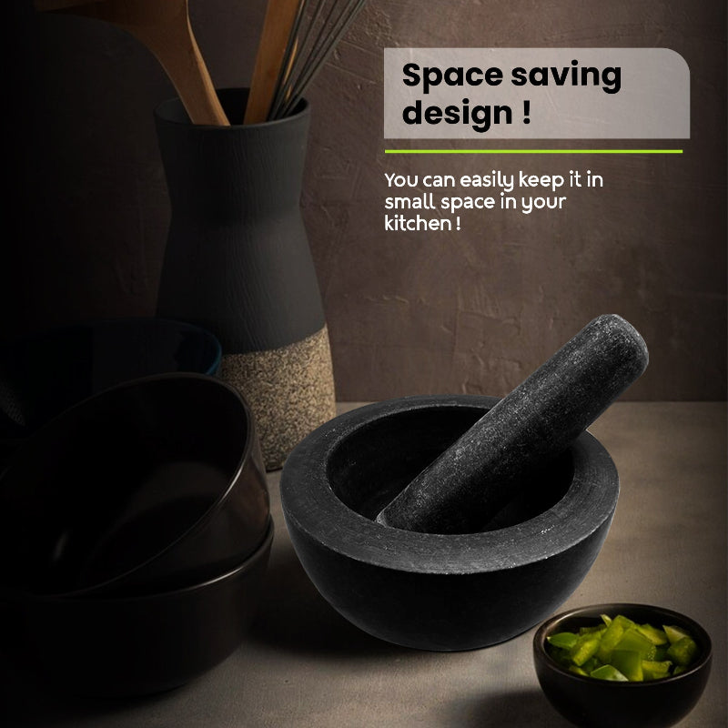Black kitchen utensils including bowls, a mortar and pestle, and a whisk container on a dark surface with text about space saving design.