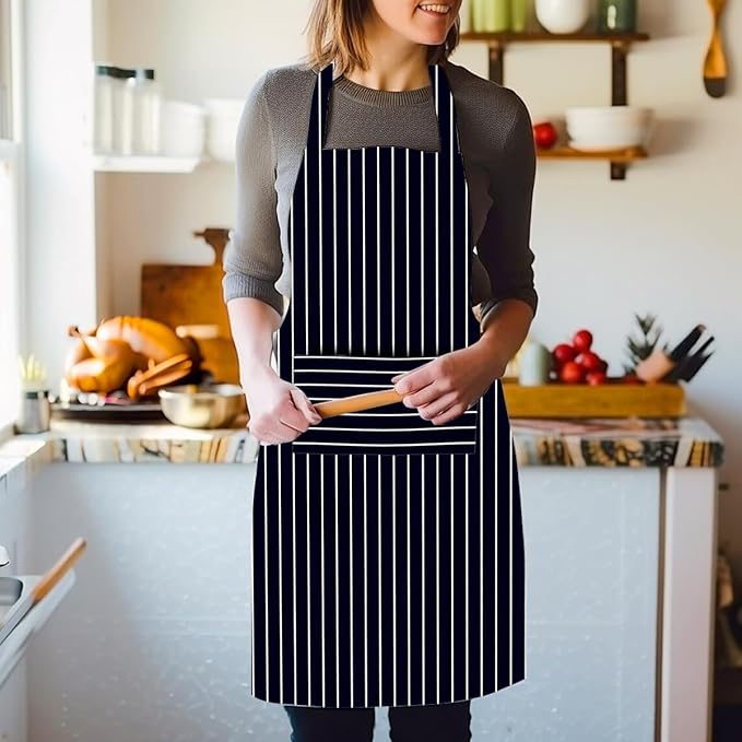 Person wearing a black apron with white stripes in a kitchen setting
