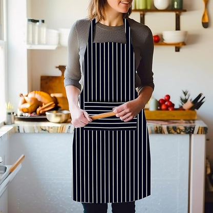 Person wearing a black apron with white stripes in a kitchen setting