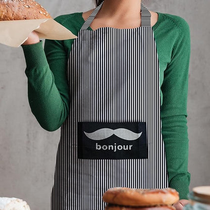 Person wearing a black and white striped apron with 'bonjour' text, holding bread.